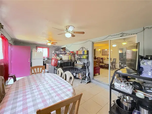 a living room with furniture a flat screen tv and a table