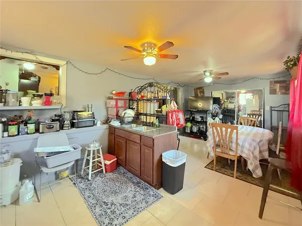 a living room with dining room and kitchen view