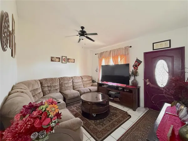 a living room with furniture and a flat screen tv
