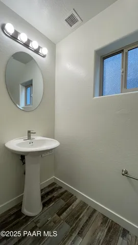 a bathroom with a sink toilet and mirror