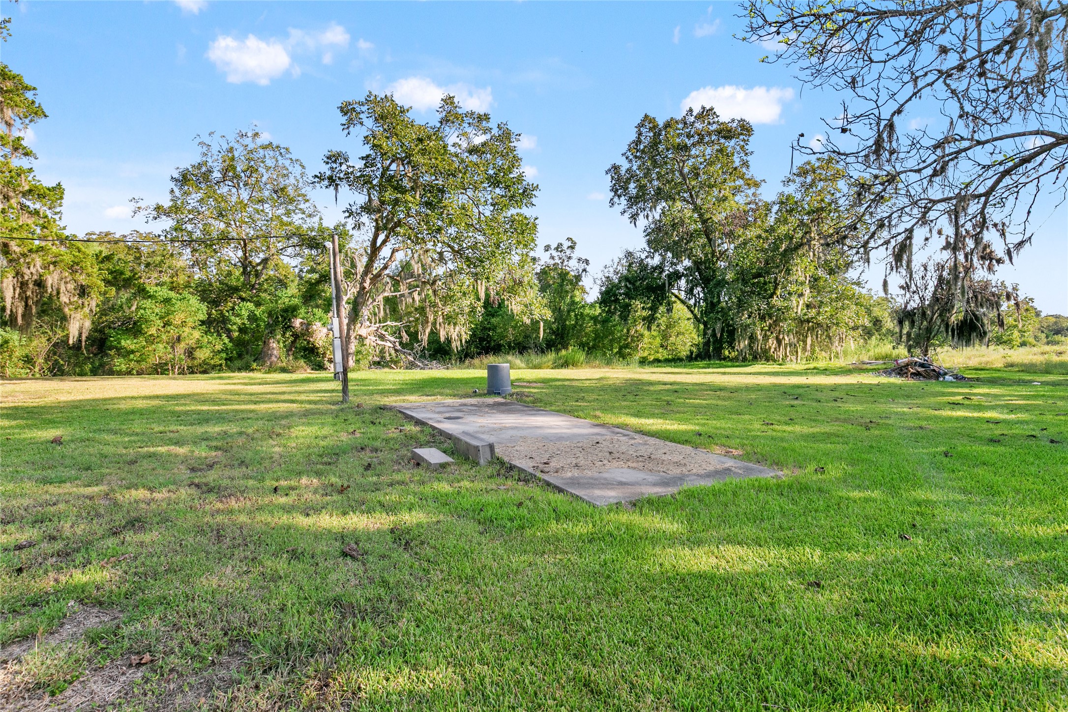 3014 Farm To Market 524 Road Sweeny, TX 77480 - Photo 10 of 18 A separate concrete RV/trailer pad has its own septic system, with a well shared between the pad and house. Two driveways and the layout provide natural separation between the two areas.