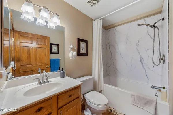 a bathroom with a sink toilet tub and shower
