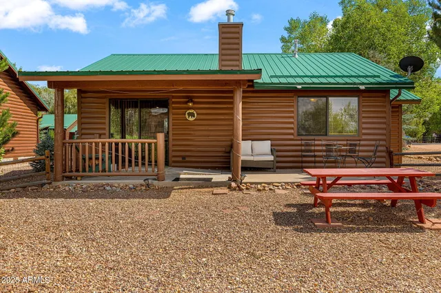 a backyard of a house with barbeque oven table and chairs