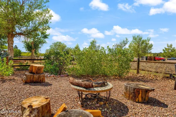 a view of a backyard with sitting area