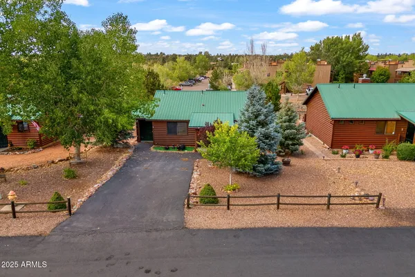 an aerial view of a house with yard and lake view