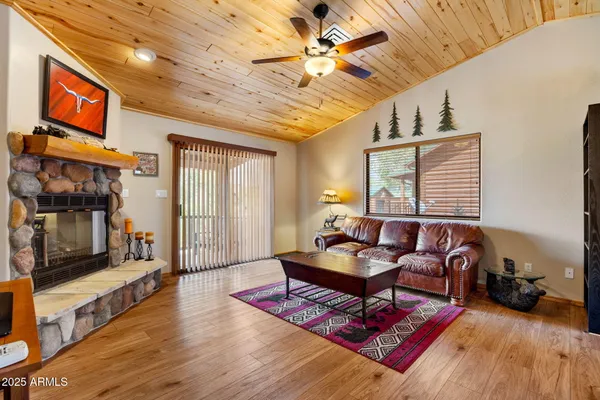 a living room with furniture a flat screen tv and a table