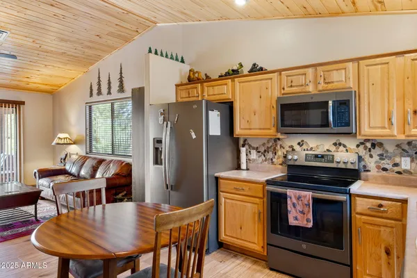 a kitchen with stainless steel appliances a stove a sink dishwasher and microwave