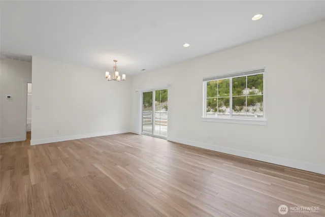 a view of a livingroom with a ceiling fan window and wooden floor