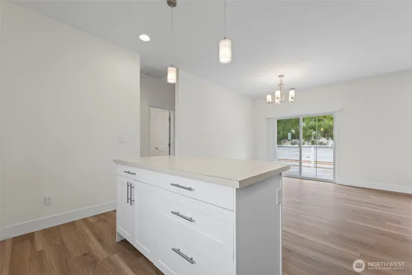 a kitchen with stainless steel appliances a stove microwave and refrigerator