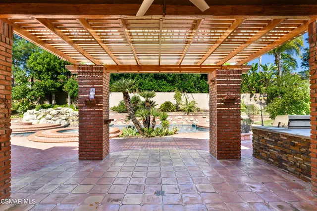 a view of a livingroom with wooden floor and a fireplace