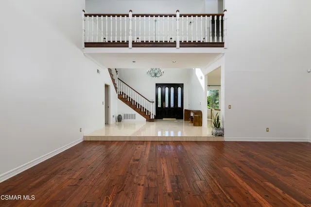 a kitchen with stainless steel appliances kitchen island granite countertop a stove a sink and a refrigerator