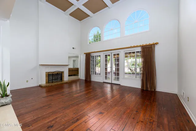 a kitchen with stainless steel appliances granite countertop a refrigerator a stove a sink and a microwave