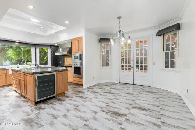 a kitchen with kitchen island a large window in it