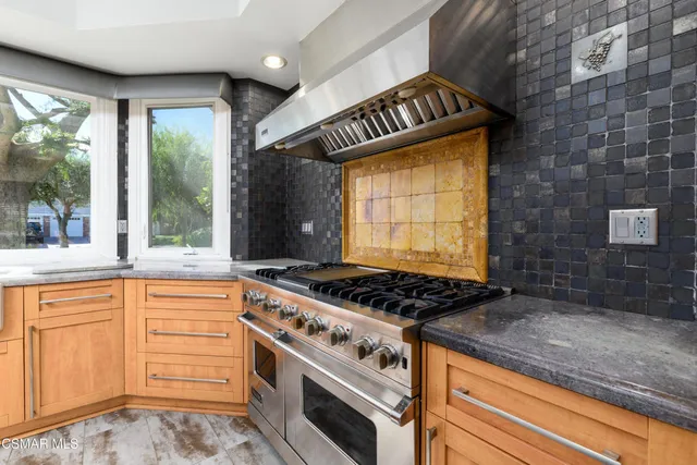 a view of a house with wooden fence