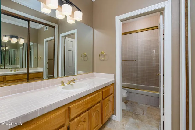 an aerial view of a city with lots of residential buildings and mountain view in back