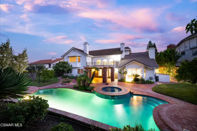 a view of a backyard with swimming pool