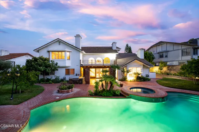 a view of a swimming pool with a yard