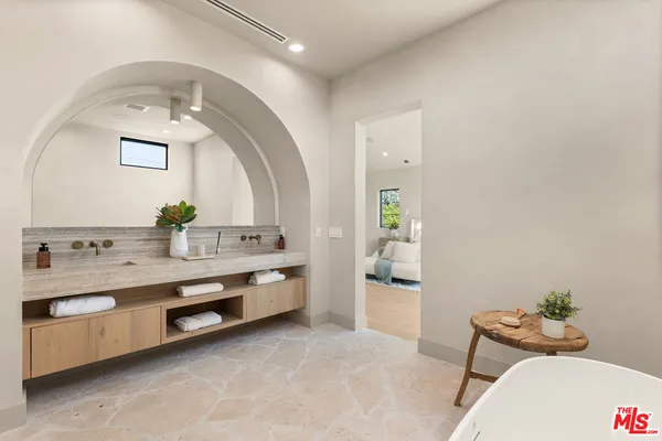 a bathroom with a granite countertop double vanity sink and mirror