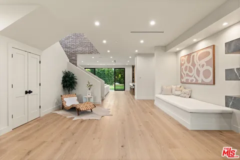 a living room with furniture fireplace and a large window