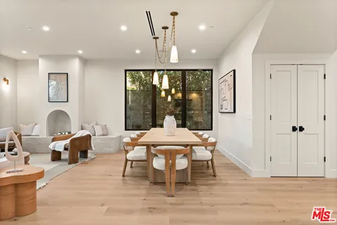 a large kitchen with stainless steel appliances kitchen island a large counter top and a wooden floors