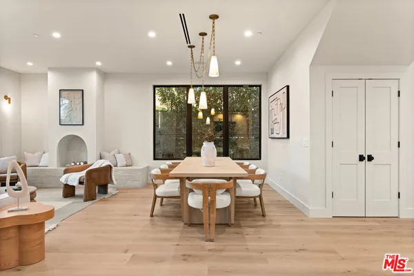 a large kitchen with stainless steel appliances kitchen island a large counter top and a wooden floors