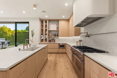 a kitchen with granite countertop cabinets and chairs