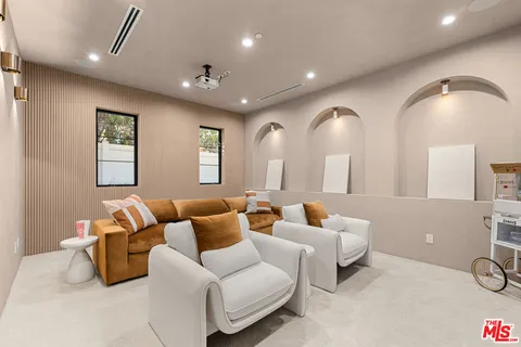 a living room with furniture and wall painting