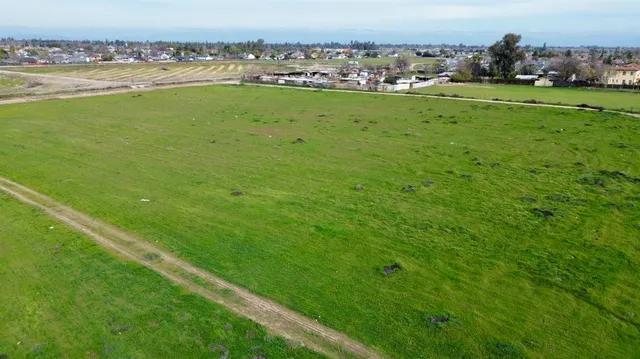 a view of a field with an ocean