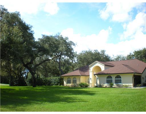 12222 Quail Ridge Drive Spring Hill, FL 34610 - Photo 1 of 1 Exterior Front - Gorgeous 3/3/2 Home sitting on VERY PRIVATE one acre lot. New 40 yr shingle roof