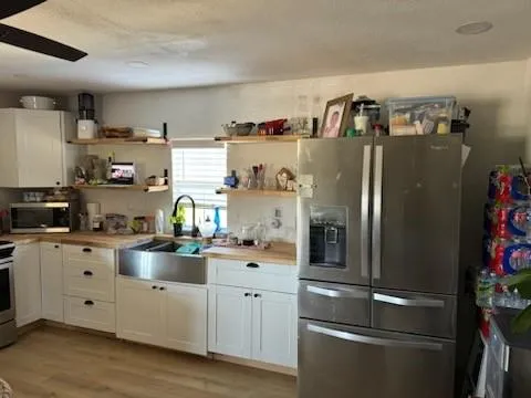 a kitchen with stainless steel appliances and white cabinets
