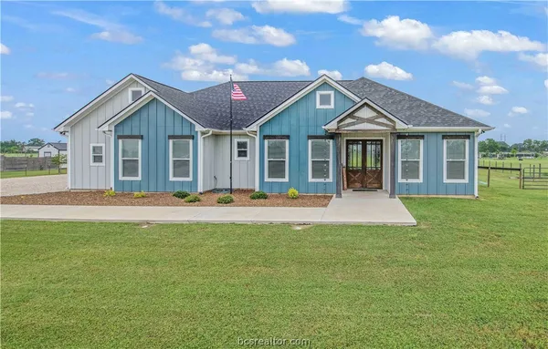 a front view of house with yard and green space