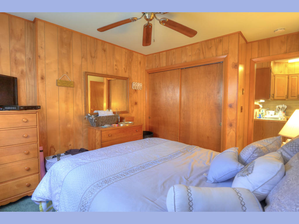 2 Carl Gardner Road Bourne, MA 02532 - Photo 27 of 30 a bedroom with a bed and a chandelier