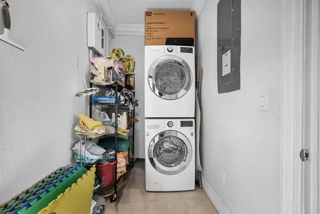 a view of a house with a small yard and a large tree