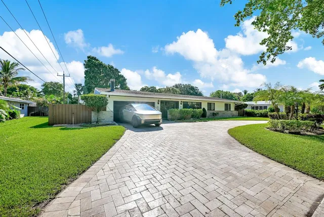 a view of a house with backyard sitting area and swimming pool