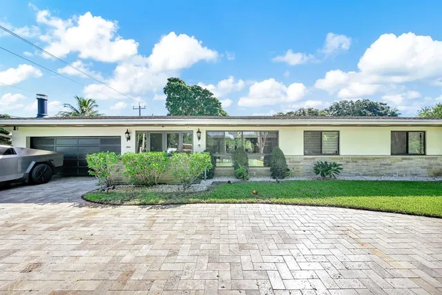 an aerial view of a house with swimming pool garden and patio