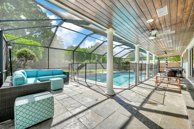 an aerial view of residential houses with outdoor space and trees