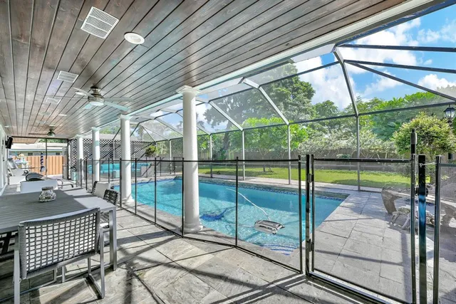 a view of a dining room with furniture and a large window