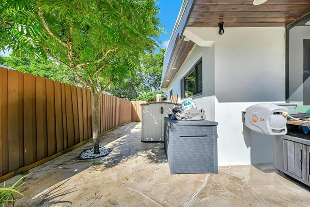 a view of a hallway with wooden floor and a living room