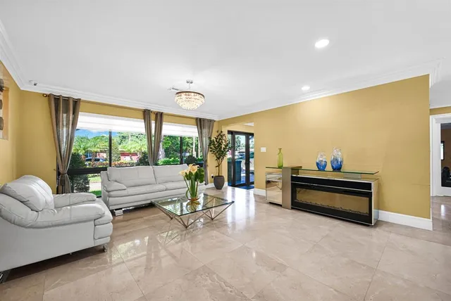 a living room with furniture and a floor to ceiling window
