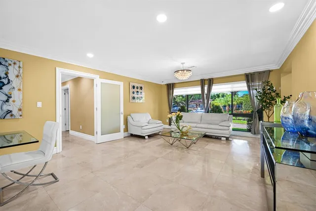 a living room with furniture and painting on the wall