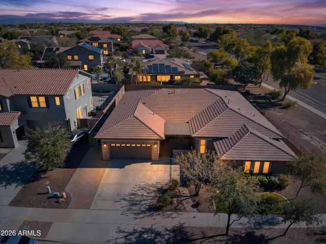 a view of a house with backyard and a tree