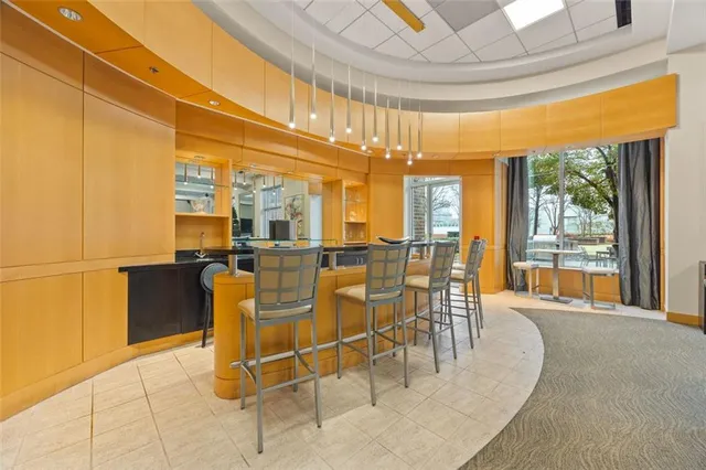 a dining room with furniture and large windows