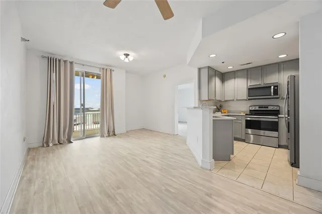 a kitchen with a refrigerator and a stove top oven