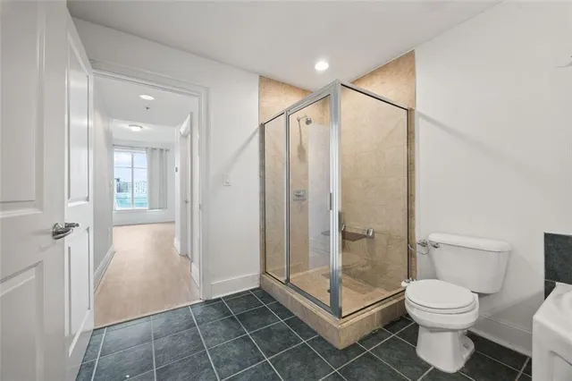 a bathroom with a toilet and a shower