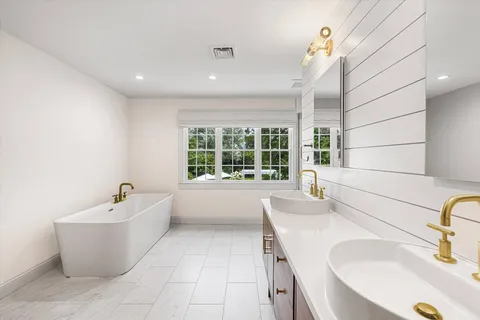a bathroom with a window and a shower