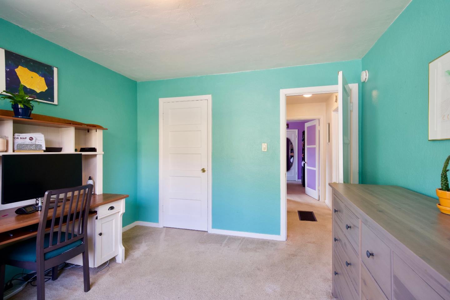 390 Pacific Avenue Pacifica, CA 94044 - Photo 13 of 24 a view of a workspace with furniture and a flat screen tv