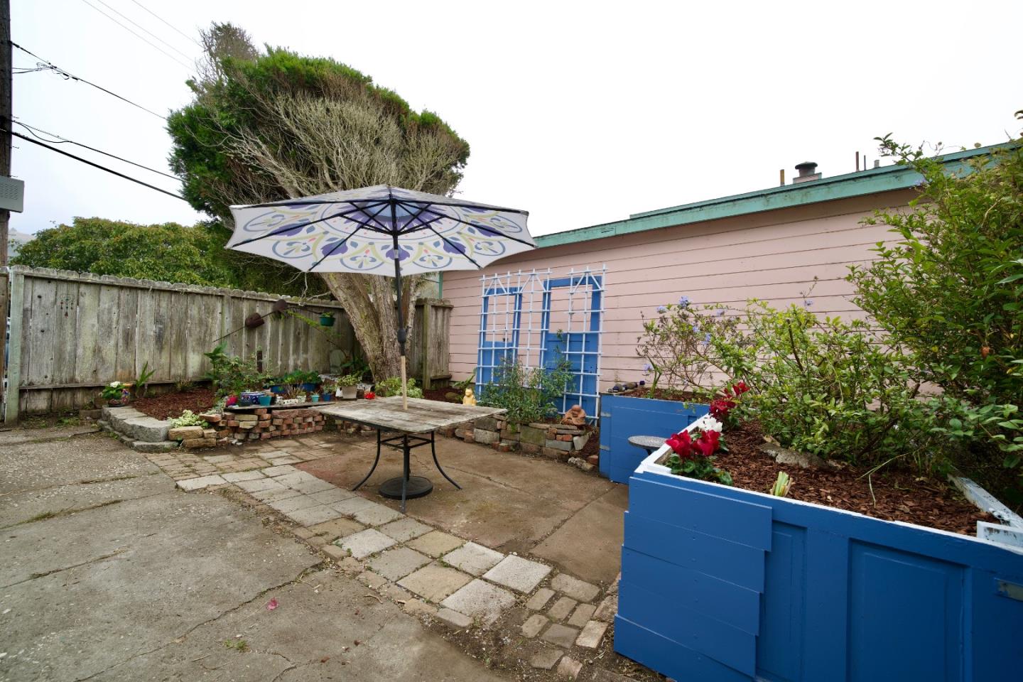 390 Pacific Avenue Pacifica, CA 94044 - Photo 24 of 24 an outdoor sitting area with furniture and umbrella