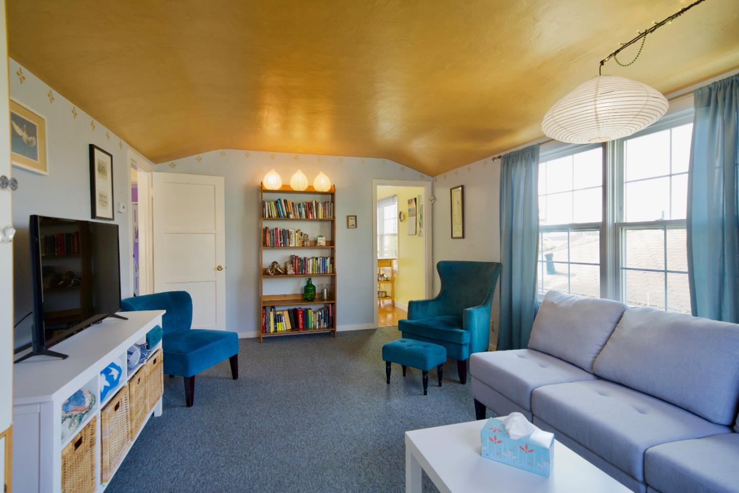 390 Pacific Avenue Pacifica, CA 94044 - Photo 4 of 24 a living room with furniture and a flat screen tv