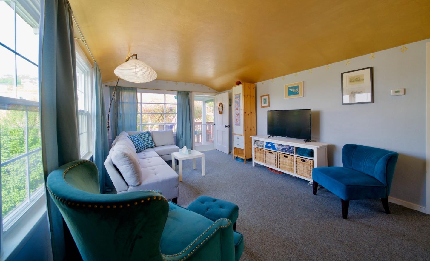 390 Pacific Avenue Pacifica, CA 94044 - Photo 5 of 24 a living room with furniture and a flat screen tv