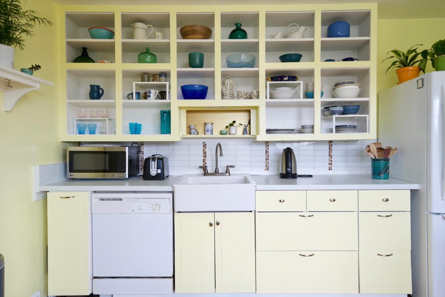 390 Pacific Avenue Pacifica, CA 94044 - Photo 6 of 24 a view of cabinets a oven and a bookshelf with wooden floor
